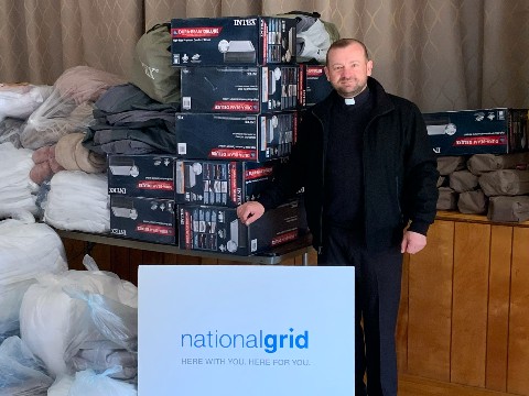 Rev. Mykola Andrushkiv with donated supplies from National Grid.