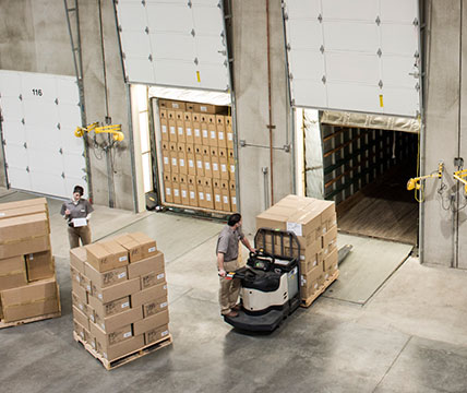 Man moving boxes in warehouse
