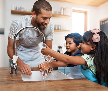Family washing hands at sink