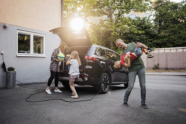 Family around electric car