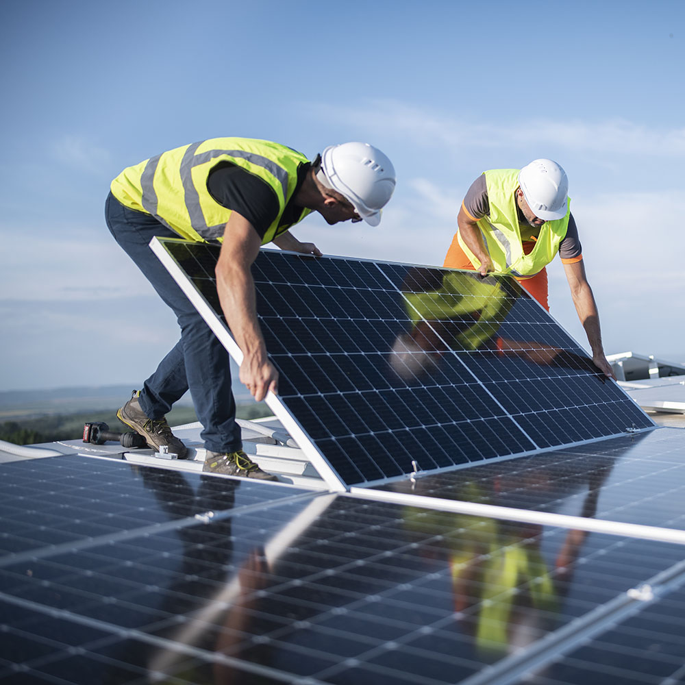 Workers installing commercial solar panel