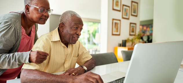 Two people looking at the laptop