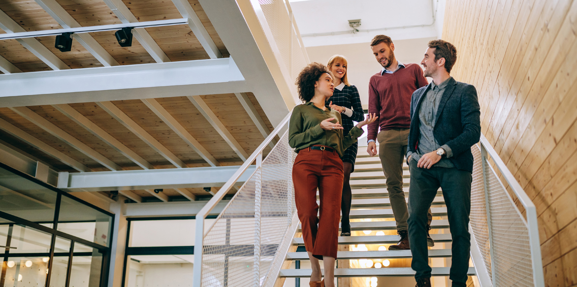 team walking down the office stairs