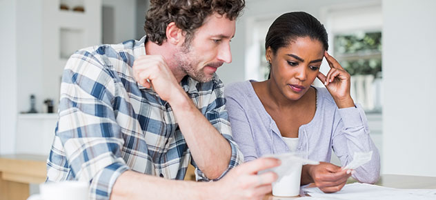 man and woman looking at a receipt