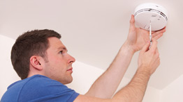 Man Installing Carbon Monoxide Detector