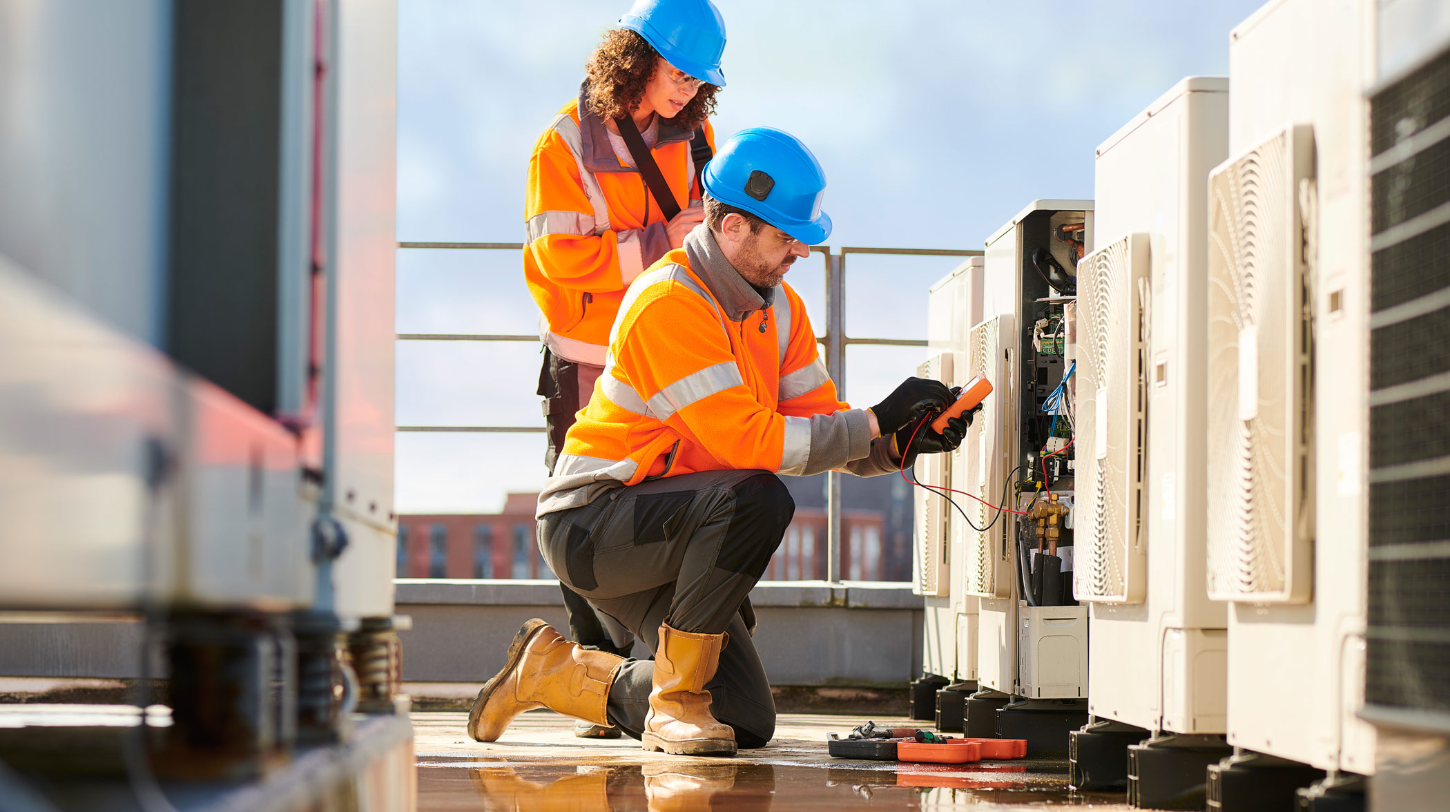 Electricians checking on heatpumps